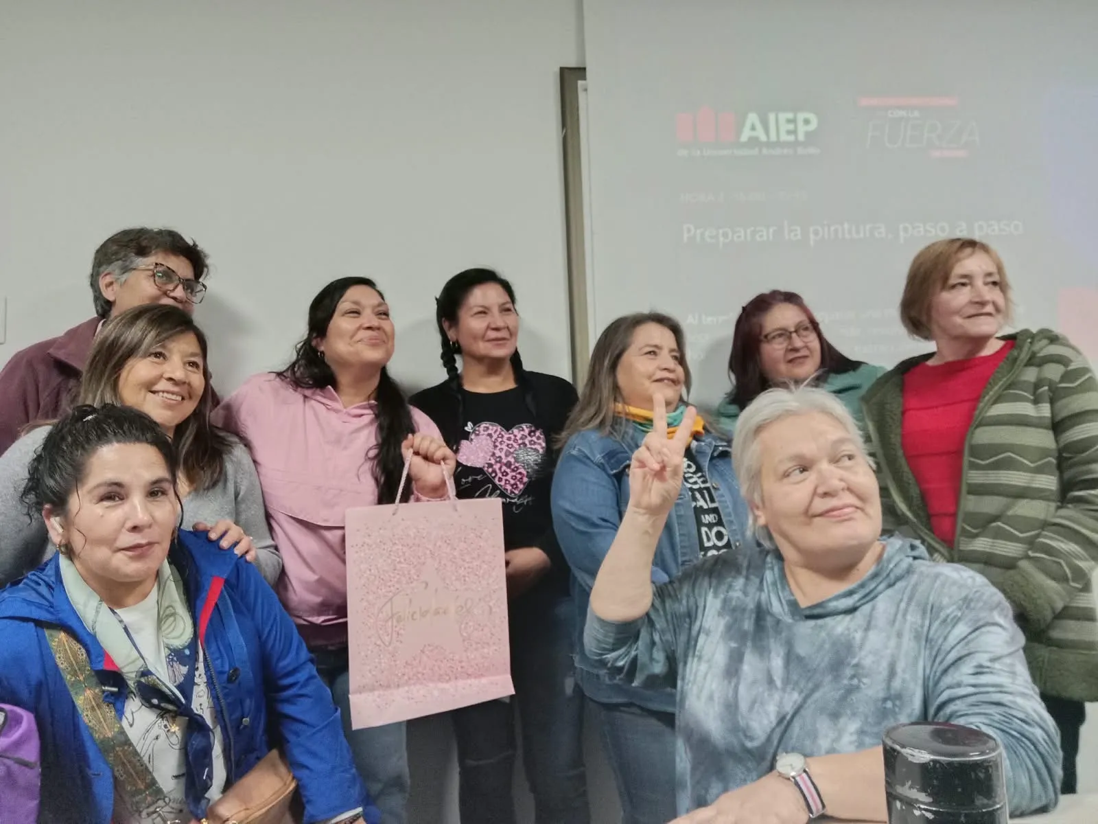 Integrantes del curso de carrocería de buses celebrando en la sala de AIEP