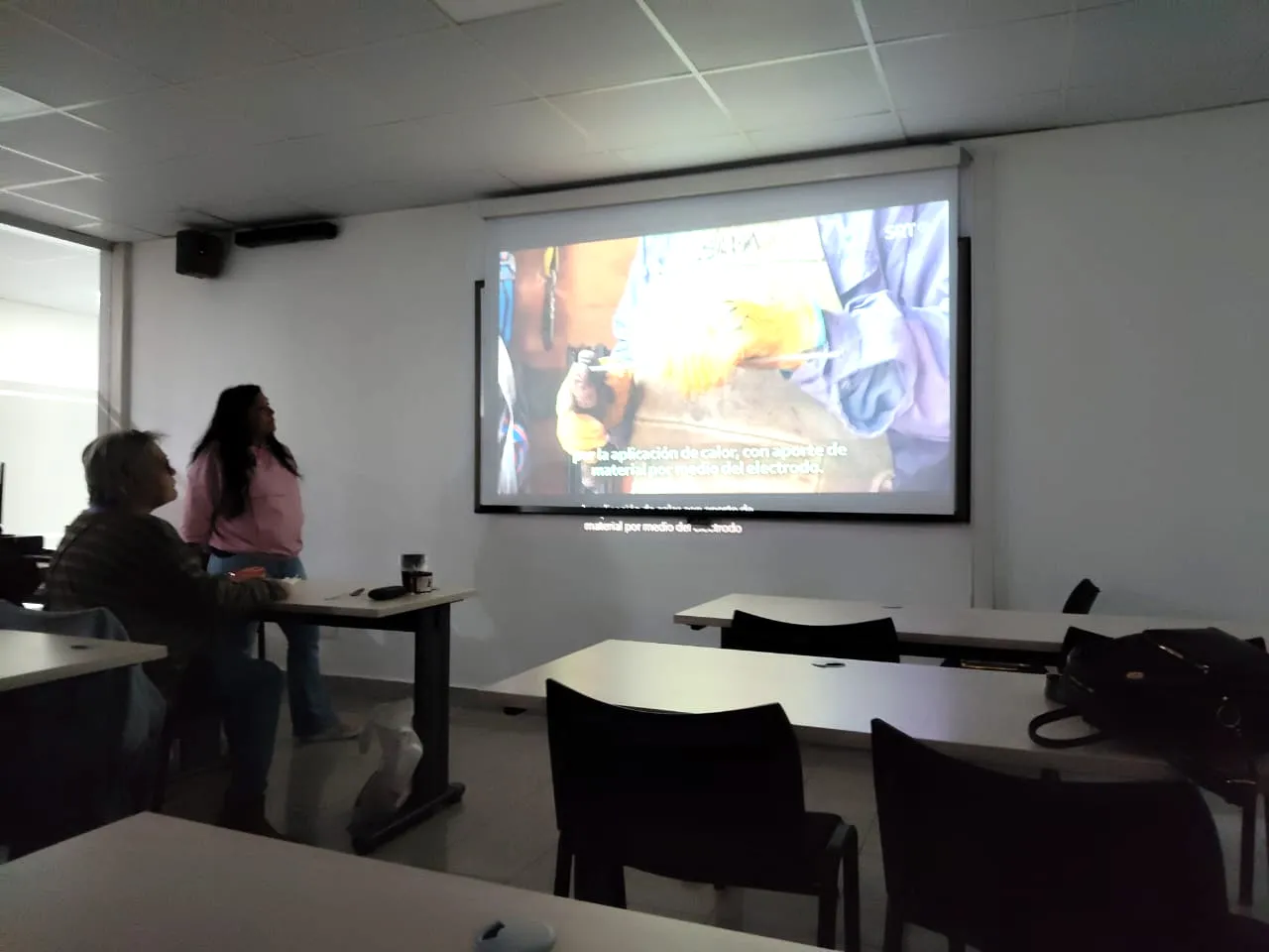Alumnos viendo un video sobre soldadura durante la clase de teoría